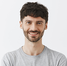 a smiling man wearing a gray T-shirt