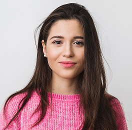 a young woman in a pink sweater